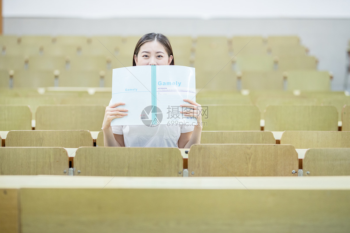 教室里用书挡着脸的可爱女生