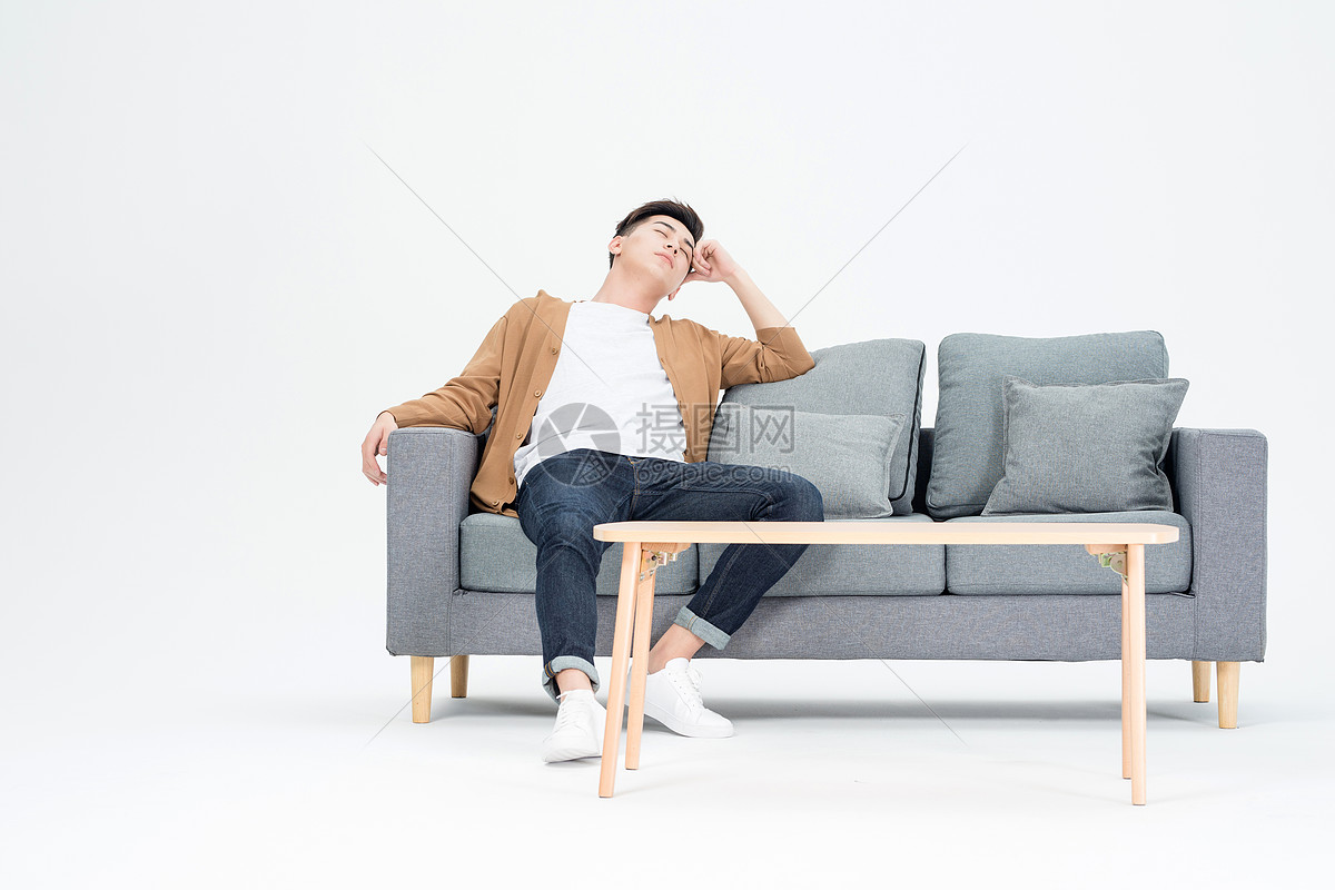 青年男性疲惫坐在沙发上