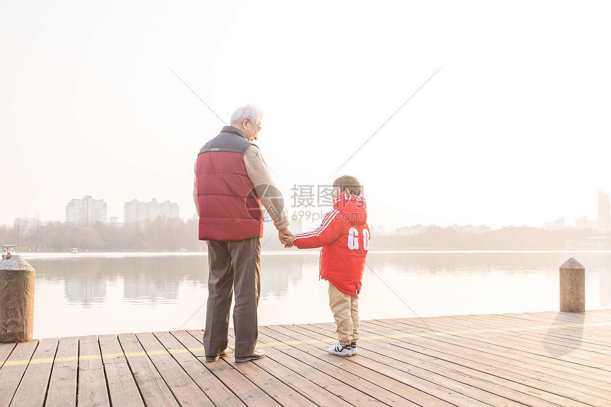 祖孙情夕阳下爷爷牵孙子背影