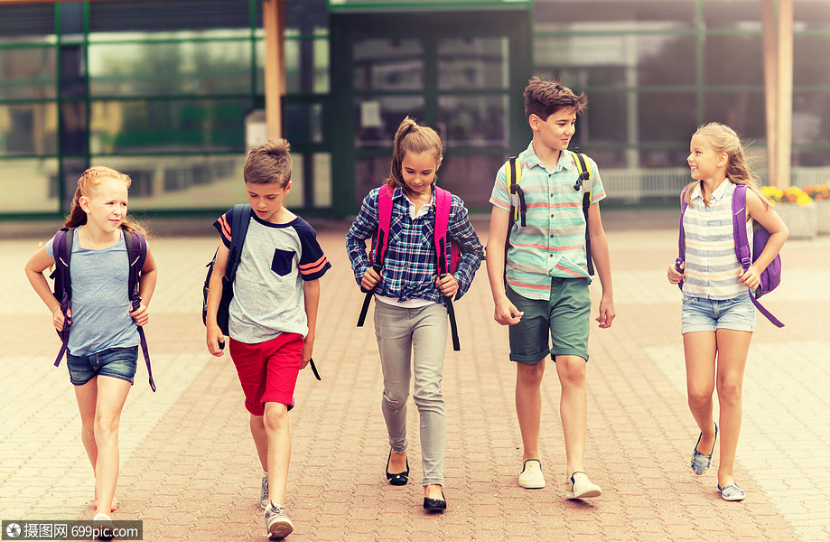 人的群快乐的小学生,背包户外散步交谈群快乐的小学生走路幸福的小孩