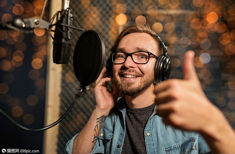 音乐,表演业务,人声音男歌手戴着耳机麦克风录音棚唱歌,并节日灯上竖