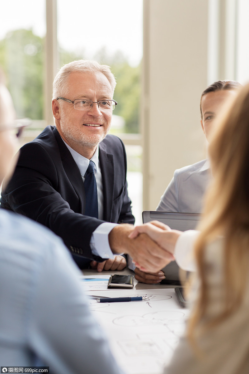 商业,人,手势,合作伙伴关系的微笑的高级商人与女办公室握手老板队