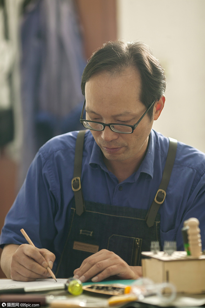 皮匠师傅在专注画皮具草稿