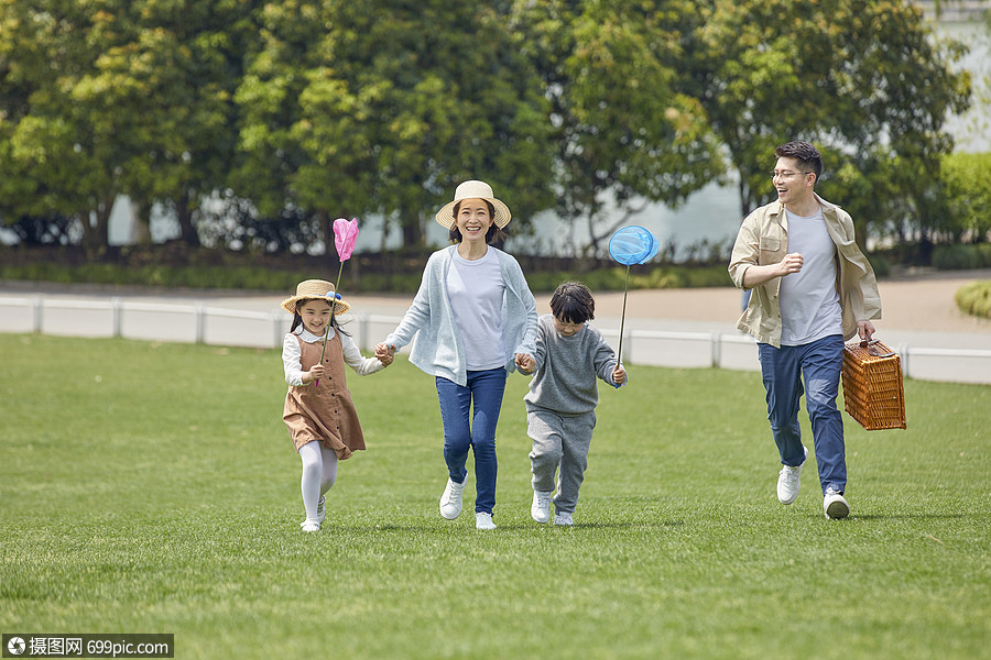 一家人户外牵手奔跑家庭亲子