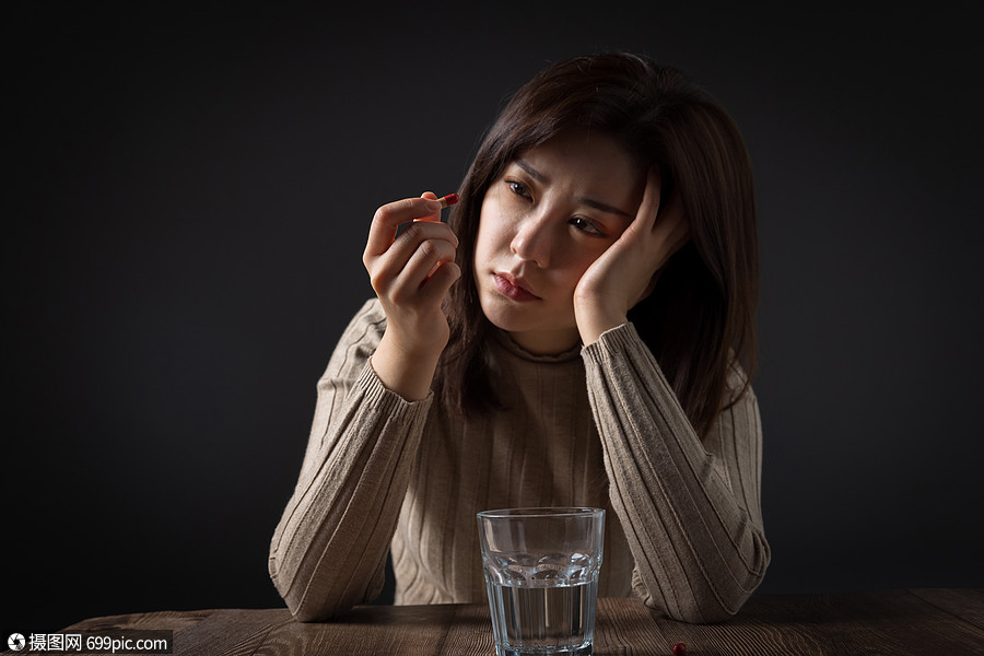 照片 人物情感 不舒服 看着药物发呆的女性.jpg